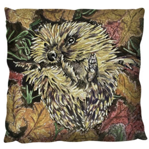 Hedgehog in the autumn leaves on a cushion