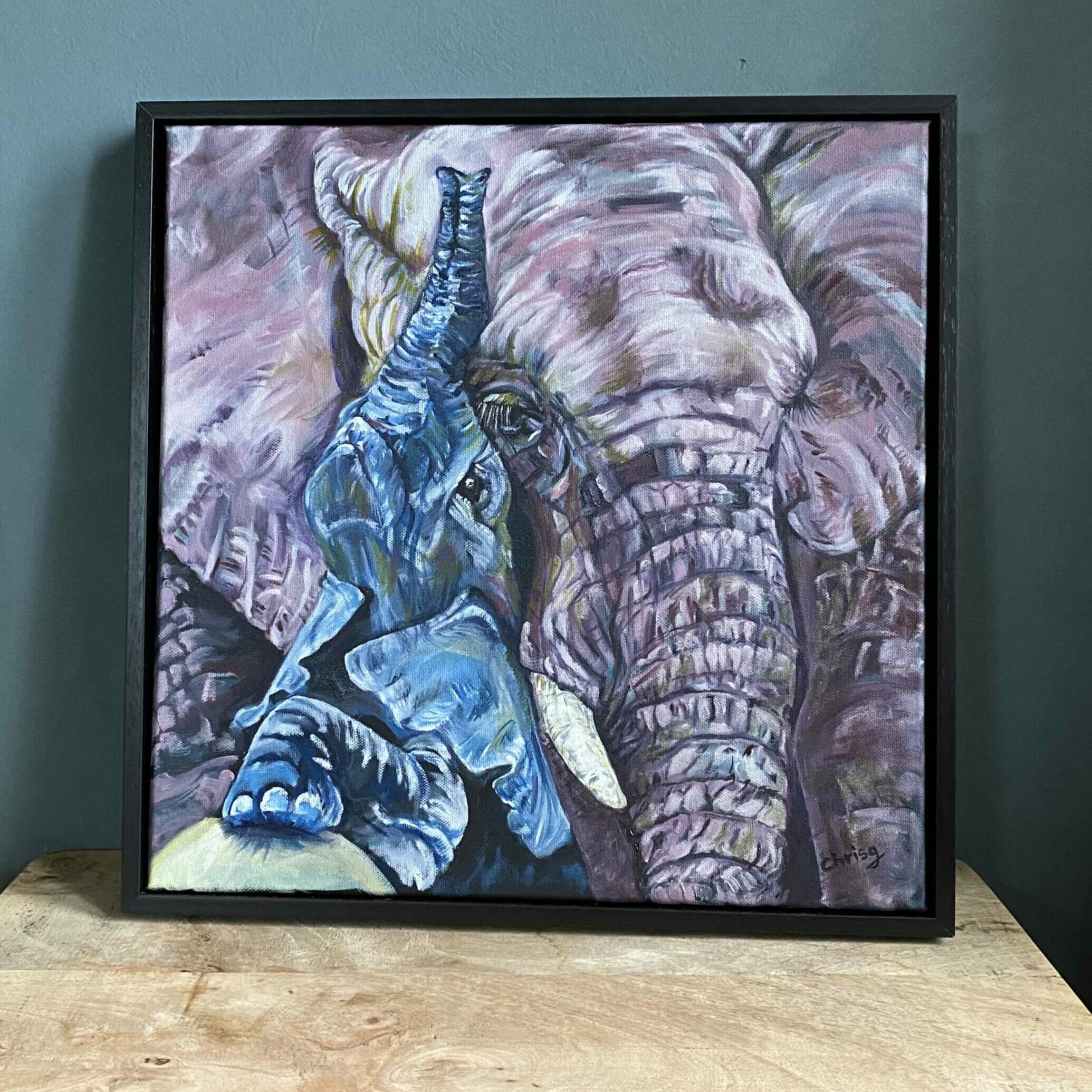 Original artwork of a baby elephant in blue snuggling up to his mums face. Oil painting .