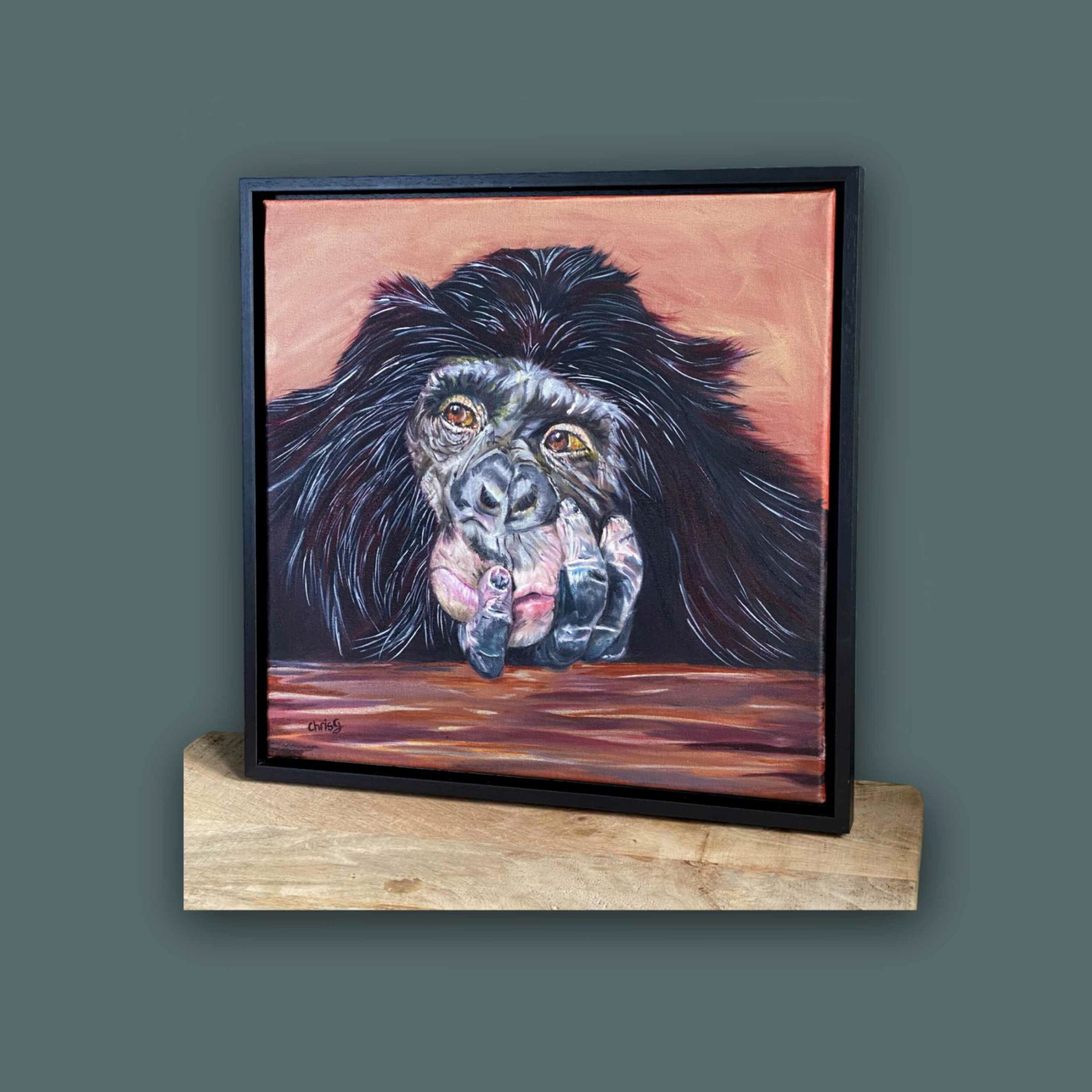 Original oil painting of Ruby my thoughtful chimp. A portrait that shows Ruby leaning on a   log with her face leant into her hand, with one finger on her mouth. She looks deep in thought . 