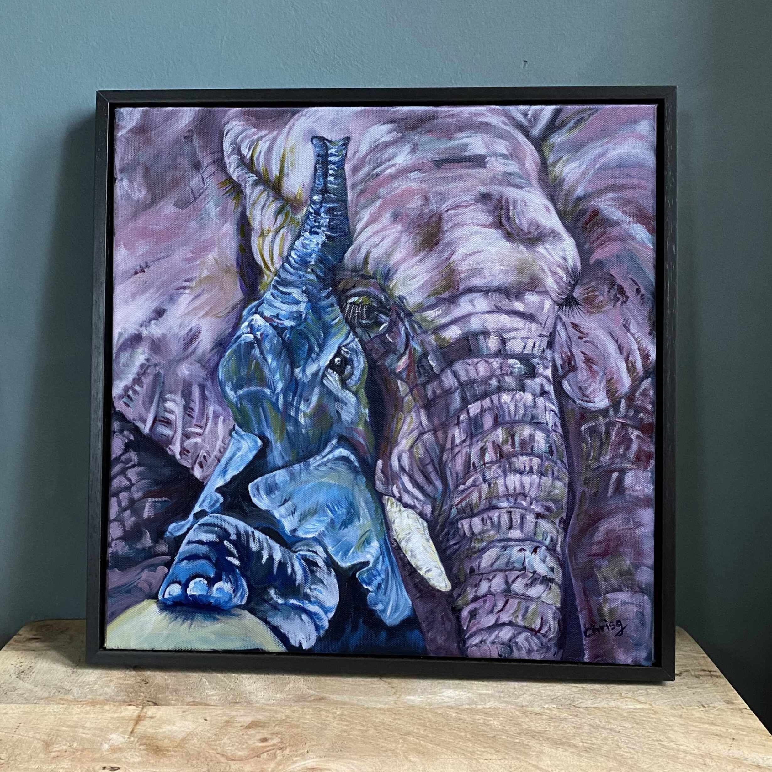 Little blue elephant is cuddling into his mum who’s pink and lilac. 
